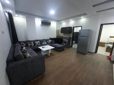 a living room with a couch and a table at الغردفه كازبلانكا ريزورت in Hurghada