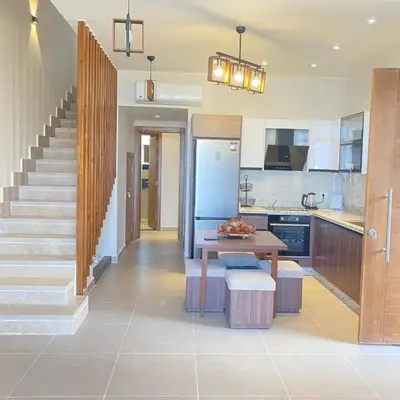 a kitchen with a table and a staircase in a house at Jade 18 A in Hurghada