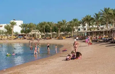 a group of people in the water at a beach at شالية فى قرية ميراج باى الغردقة in Hurghada