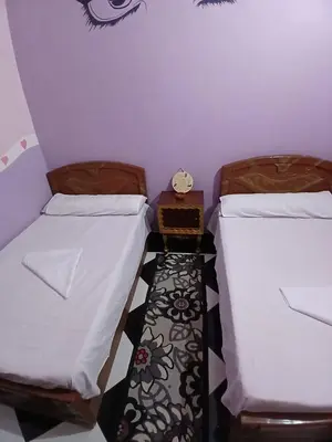 two beds sitting next to each other in a room at Hamada guest house in Aswan