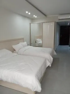 two white beds in a room with a mirror at Scandic Resort Hurghada in Hurghada