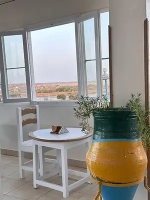 a room with a table and a vase with a plant at Ekadolli Nubian house- by kerma hospitality in Aswan