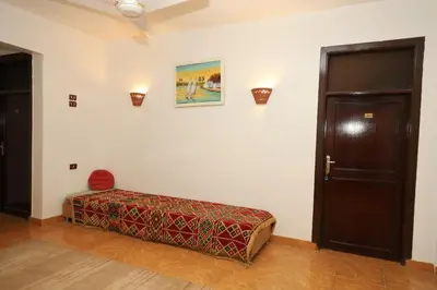 a room with a bed sitting next to a door at Ekadolli Nubian house- by kerma hospitality in Aswan