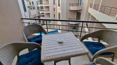 a table and chairs on the balcony of a building at Pohodové bydlení v Hurghade in Hurghada