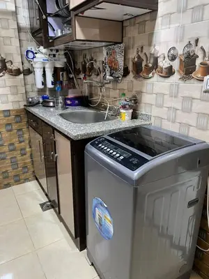 a small kitchen with a sink and a dishwasher at شقة خلف فندق الإليزي in Hurghada