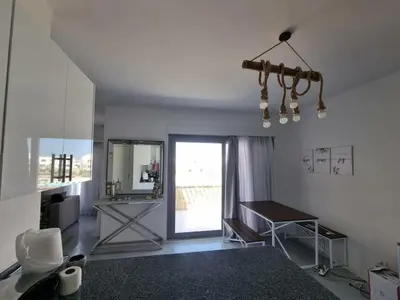 a living room with a table and a mirror at Spacious Penthouse in Hurghada