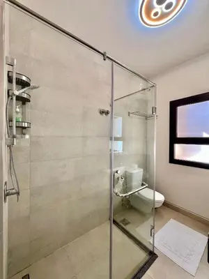 a glass shower in a bathroom with a toilet at Villa with pool Miska Soma Bay in Hurghada