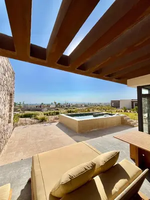 a patio with a couch and a view of a pool at Villa with pool Miska Soma Bay in Hurghada