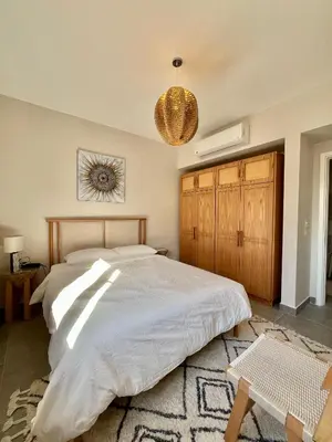 a bedroom with a large bed and a rug at Villa with pool Miska Soma Bay in Hurghada