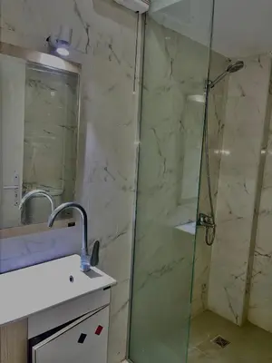 a bathroom with a shower with a glass door at Palma Resort in Hurghada