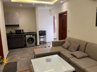 a living room with a couch and a table at Dream Chalet In Mirage Bay Resort in Hurghada