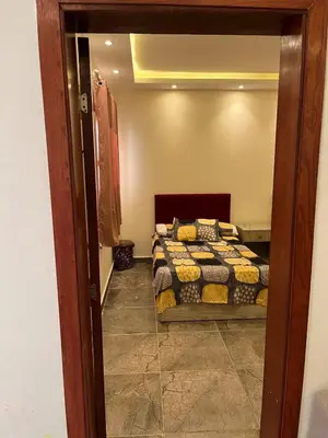a bedroom with two beds in a room with a mirror at Dream Chalet In Mirage Bay Resort in Hurghada