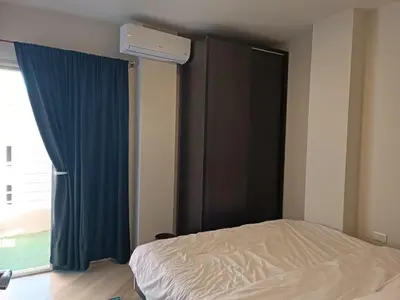 a bedroom with a bed and a window with blue curtains at marvel princes in Hurghada