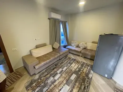 a living room with a couch and a tv in it at marvel princes in Hurghada