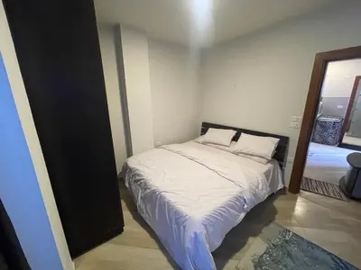 a small bedroom with a bed with white sheets at marvel princes in Hurghada