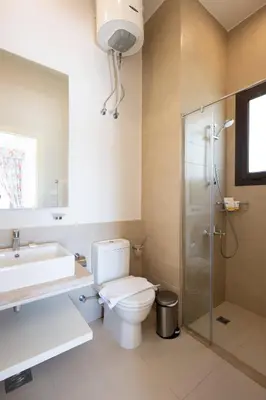 a bathroom with a toilet and a sink and a shower at VESTA - El Gouna Residence in Hurghada