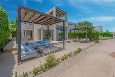 a house with a blue couch in a yard at The Lake View Villa 4BR at Tawila El Gouna in Hurghada