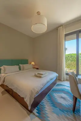 a bedroom with a bed and a large window at The Lake View Villa 4BR at Tawila El Gouna in Hurghada
