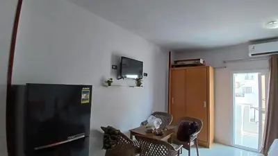 a room with a black refrigerator and a table and chairs at Tiba view in Hurghada