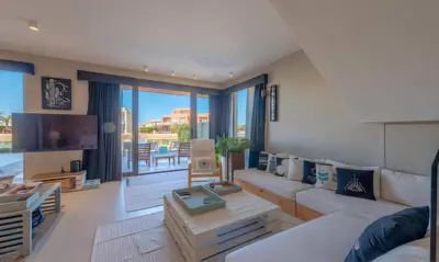 a living room with a couch and a tv at Luxury Stays in Tawila El Gouna in Hurghada