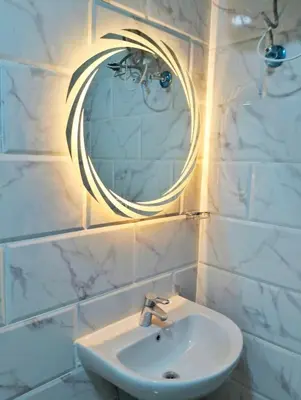 a bathroom with a sink and a mirror on the wall at Luxury apartment with beautiful view and free private beach in Hurghada