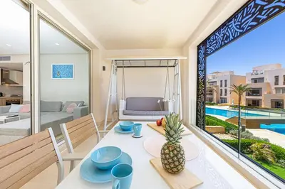 a dining room with a table with a pineapple on it at Special apartment with Pool and Seasideview, El Gouna in Hurghada