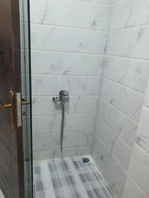 a bathroom with a shower with a glass door at جوليانا بيتش ريزورت in Hurghada
