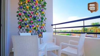 a room with white chairs and a wall covered in flowers at Touristic centre beach1 in Hurghada