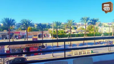 a view of a city with palm trees and buildings at Touristic centre beach1 in Hurghada