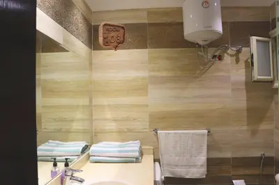 a bathroom with a sink and a clock on the wall at Touristic centre beach1 in Hurghada