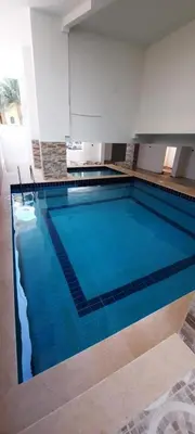 a large blue swimming pool in a building at Royal view suite in Hurghada