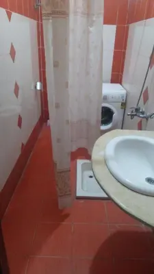 a bathroom with a sink and a shower curtain at The Nile apartment in Luxor