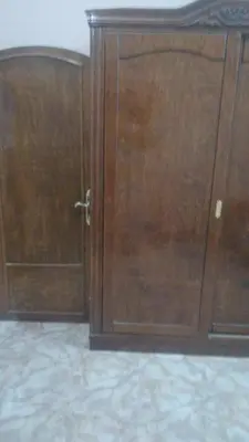 a pair of wooden doors in a room at The Nile apartment in Luxor