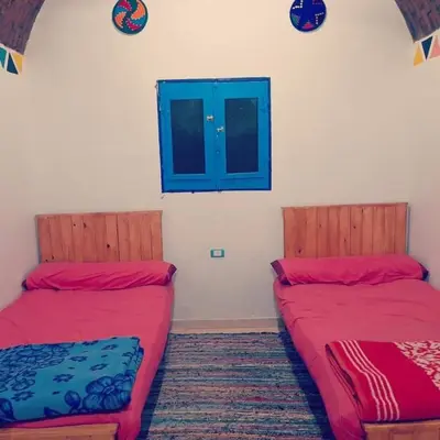 two beds sitting next to each other in a room at Kody doll in Jazīrat Suhayl
