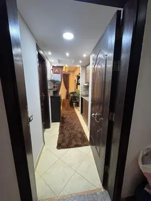 a hallway with an open door to a room with a kitchen at كمباوند فلورينزا خمسين وسط الغردقه in Hurghada