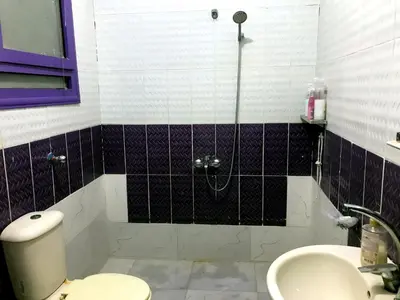 a bathroom with a shower and a toilet and a sink at room2 a room in Hostel of 4 rooms in Hurghada