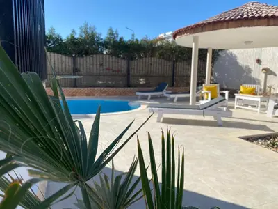 a backyard with a pool and a gazebo at Magawish Hurghada Apartement 1 in Hurghada