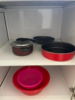 four pots and pans on a shelf in a refrigerator at Bayt Hassan S19 - Super spacious roof top One Bedroom apartment in Hurghada