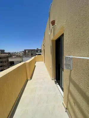a balcony of a building with a view of a city at Bayt Hassan S19 - Super spacious roof top One Bedroom apartment in Hurghada