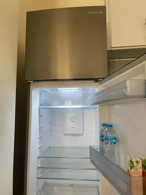 an open refrigerator with two bottles of water in it at Bayt Hassan A3 - 2 bedrooms European style Apartment in Hurghada