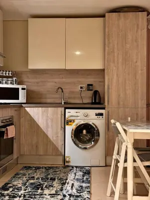 a kitchen with a washing machine in a kitchen at studio in El Gouna-mangroovy , Egypt in Hurghada