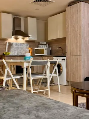 a kitchen with a table and chairs in a room at studio in El Gouna-mangroovy , Egypt in Hurghada