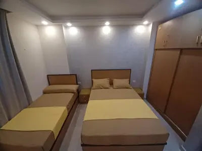 two beds in a small room with lights at ميراج باي ريزورت منتجع لافستا in Hurghada