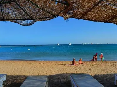 a group of people sitting on the beach at touristic centre Andalusia in Hurghada