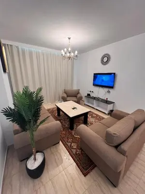 a living room with two couches and a tv at touristic centre Andalusia in Hurghada
