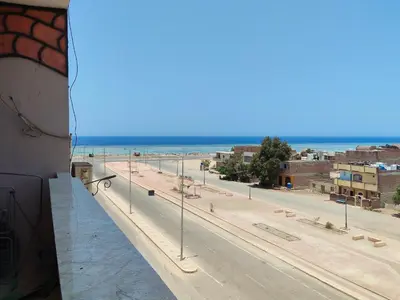 a view of a street with the ocean in the background at Hamza home in Quseir