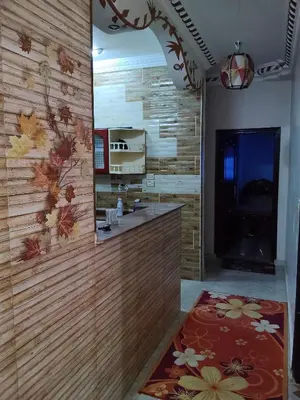 a kitchen with a wooden wall with a mirror at Sea view in Quseir