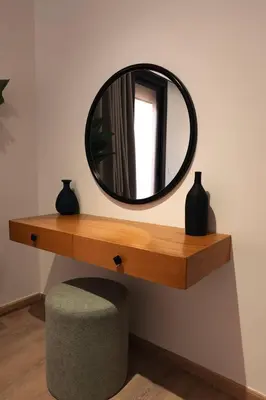 a mirror on a shelf with a ottoman and a stool at Serene 1BR Haven Kamaran in Hurghada