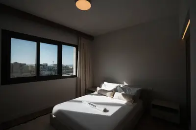 a bedroom with a large white bed with a window at Fanadir Marina Plunge Pool & Sea View in Hurghada