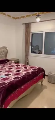 a bedroom with a bed and a window at Poseidon Apartments in Hurghada